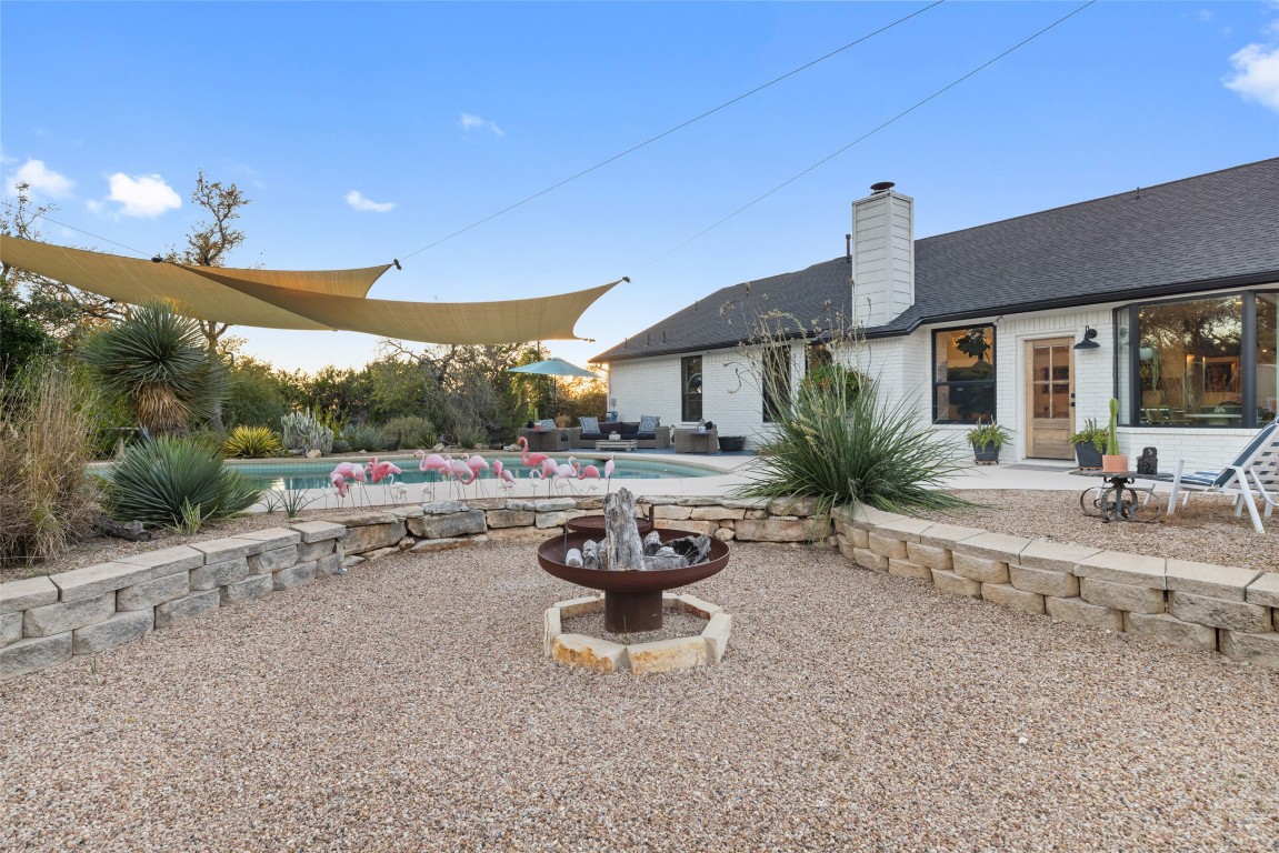 120 Oak Springs Drive Dripping Springs, TX 78620 - Photo 32 of 35 a view of a patio with a table and chairs