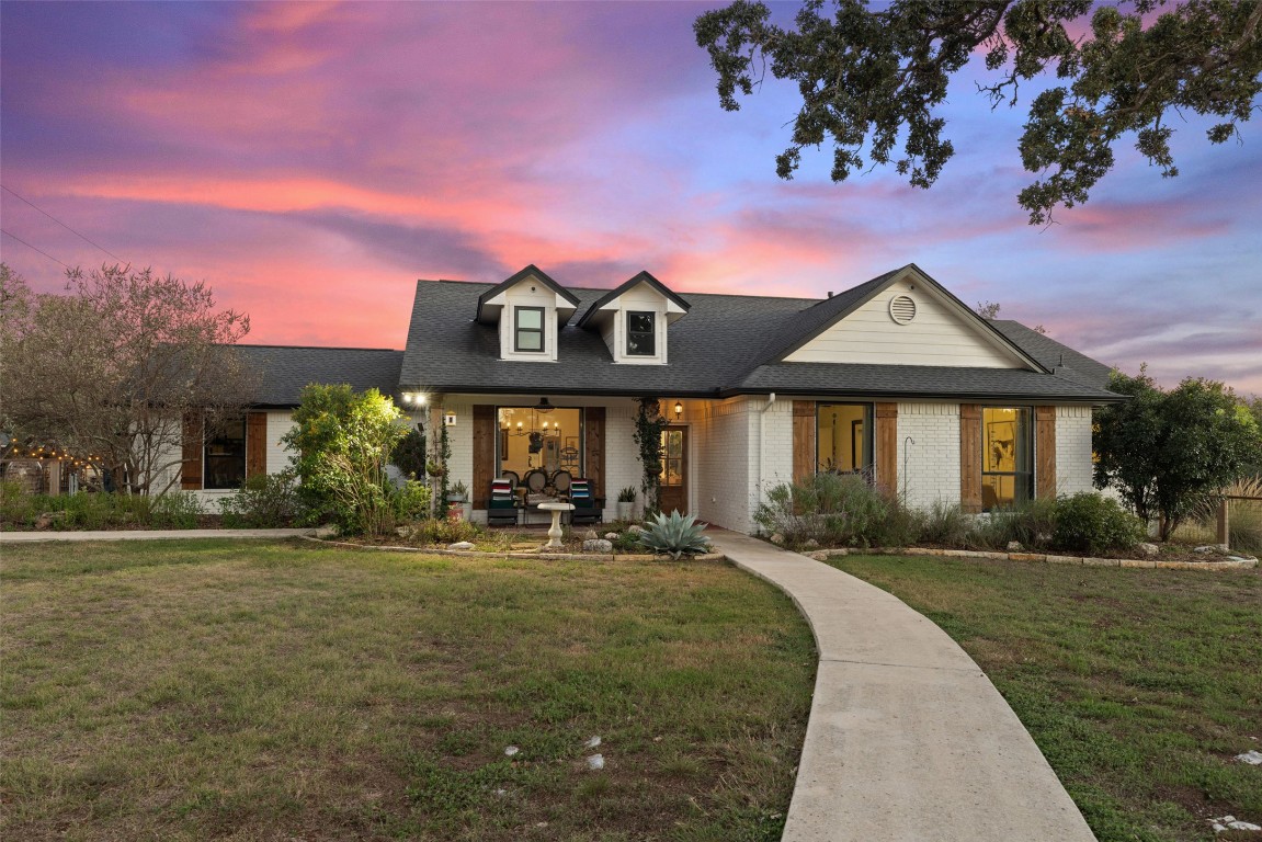 120 Oak Springs Drive Dripping Springs, TX 78620 - Photo 34 of 35 a front view of a house with a yard