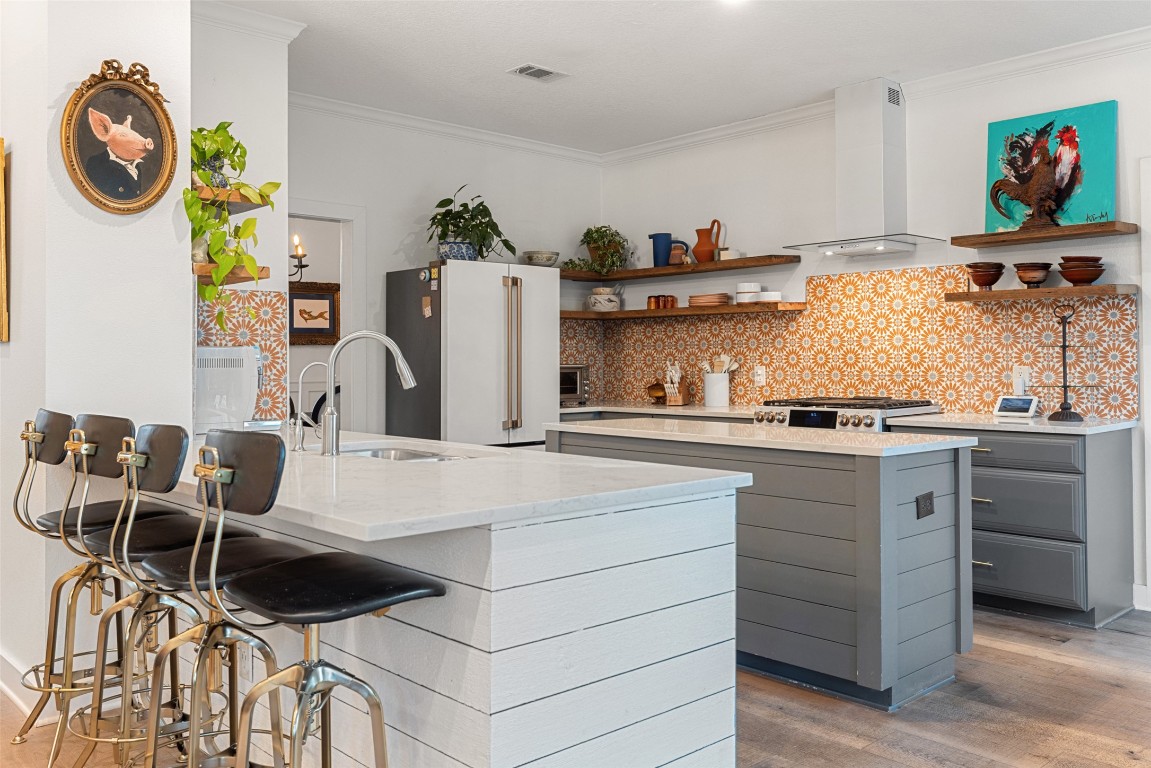 120 Oak Springs Drive Dripping Springs, TX 78620 - Photo 5 of 35 Kitchen featuring open shelves, light stone countertops, ornamental molding, tasteful backsplash, and high end white fridge