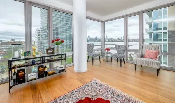 a living room with furniture and a floor to ceiling window