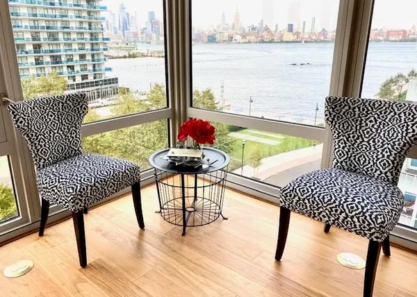 a living room with furniture and a floor to ceiling window