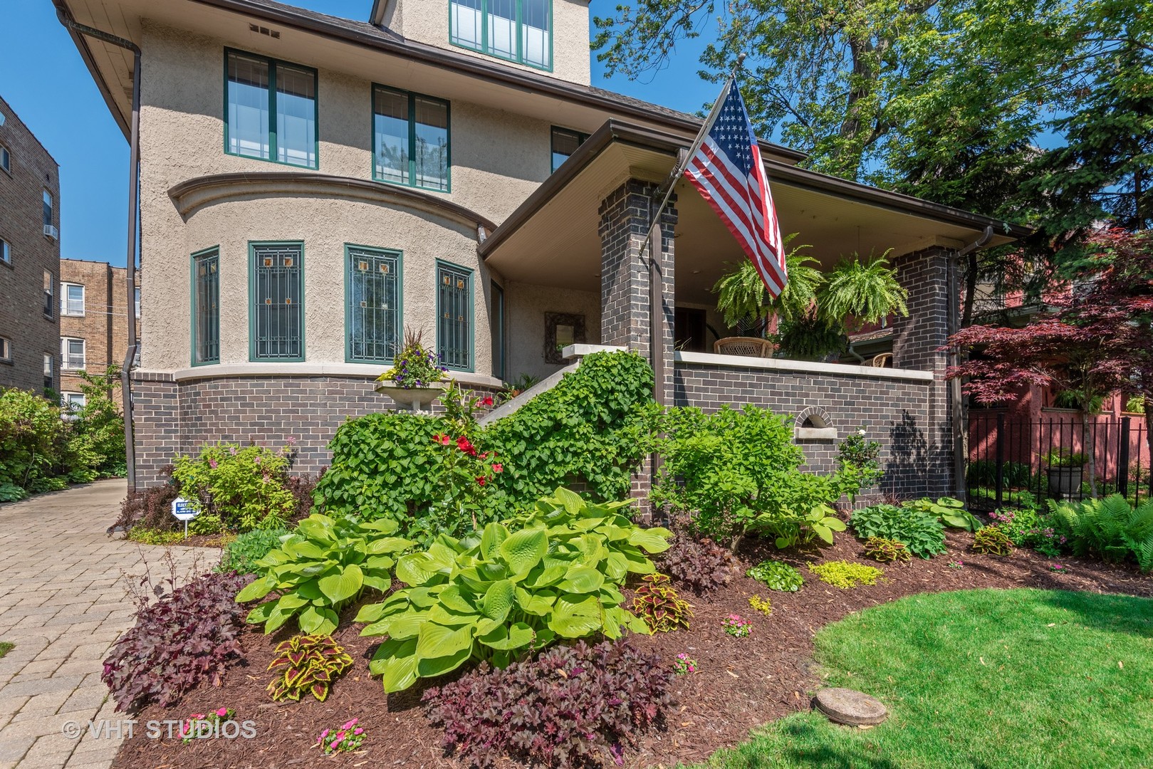 7406 North Sheridan Road Chicago, IL 60626 - Photo 2 of 37 a front view of a house with a yard
