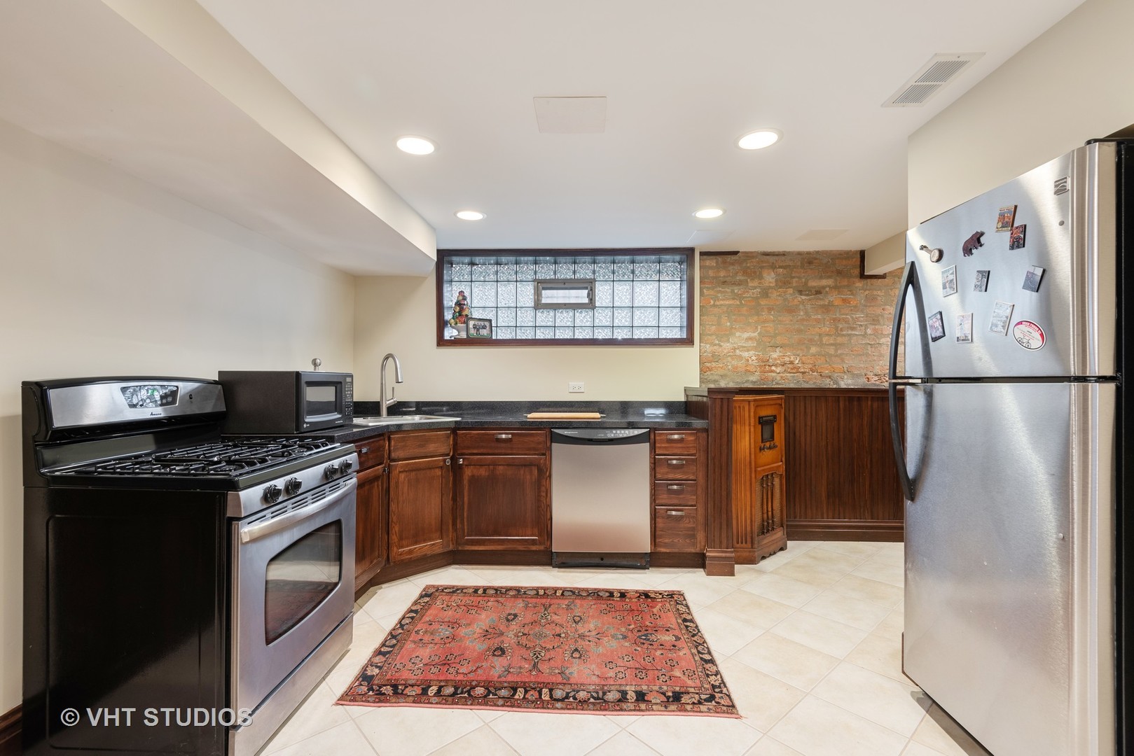 7406 North Sheridan Road Chicago, IL 60626 - Photo 25 of 37 a kitchen with stainless steel appliances granite countertop a stove a refrigerator and a sink