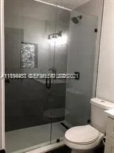 a bathroom with a toilet a sink and shower
