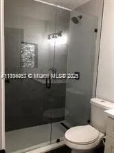 a bathroom with a toilet a sink and shower
