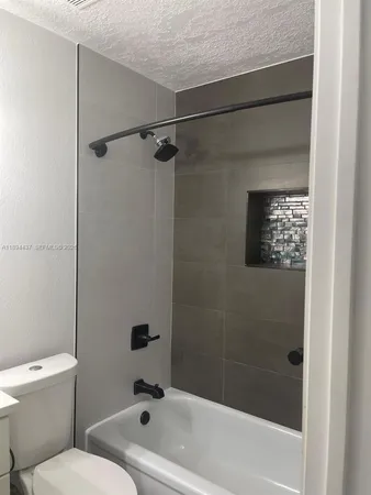 a bathroom with a toilet and a bathtub