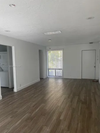 a kitchen with granite countertop a stove and a microwave