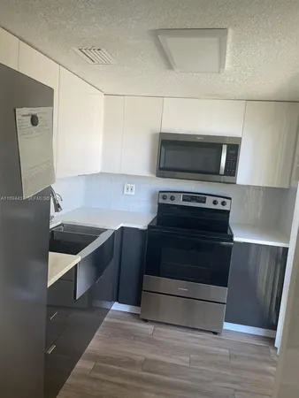 a view of a kitchen with an empty space and a window
