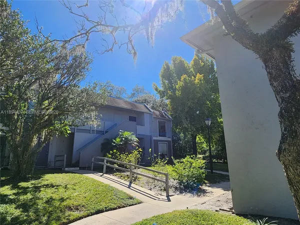 a view of small yard in front of house with outdoor seating