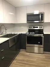 a kitchen with a stove and a microwave