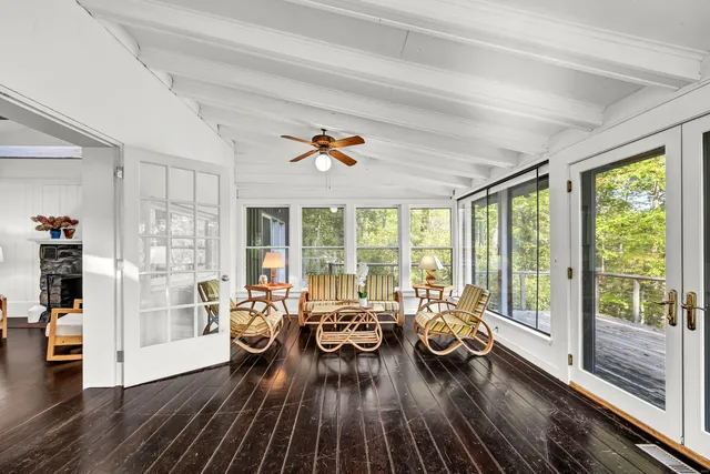 a living room with furniture and a large window with garden view