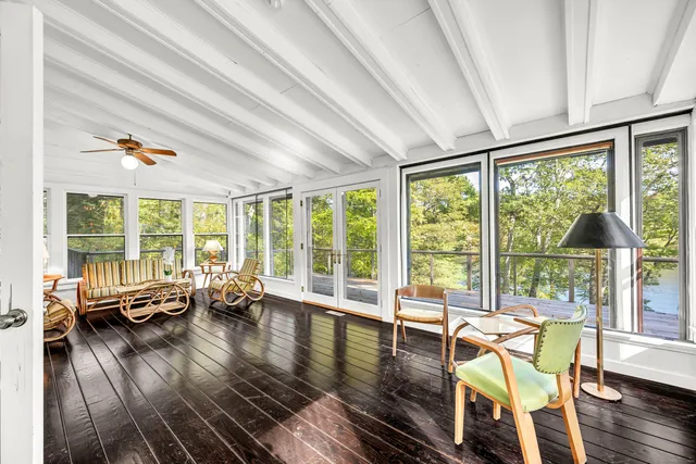 a living room with furniture and floor to ceiling windows