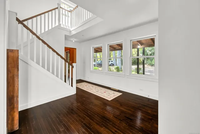 a view of an entryway with wooden floor