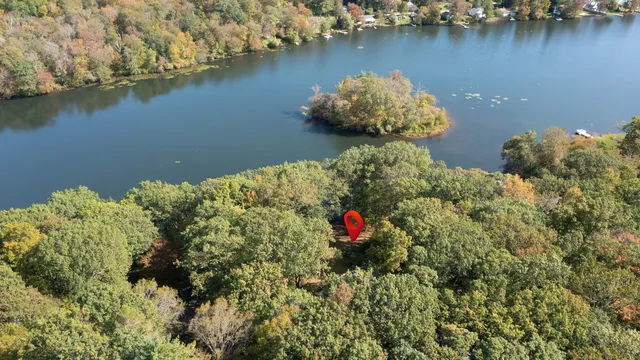 an aerial view of a house with a lake view