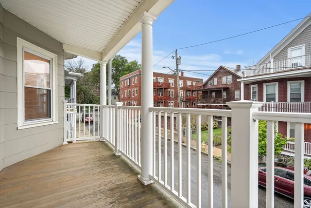 a view of a house with wooden floor and wooden fence