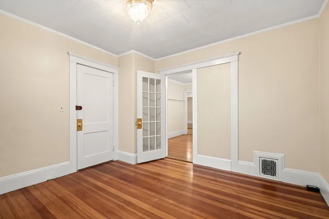 a view of empty room with wooden floor