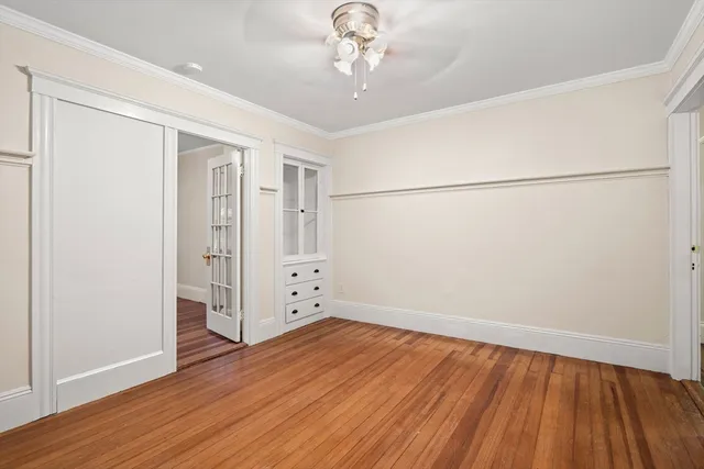 wooden floor in an empty room with a window