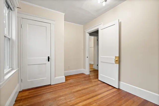a view of hallway with wooden floor