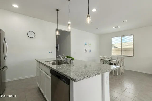 a kitchen with center island table and chairs