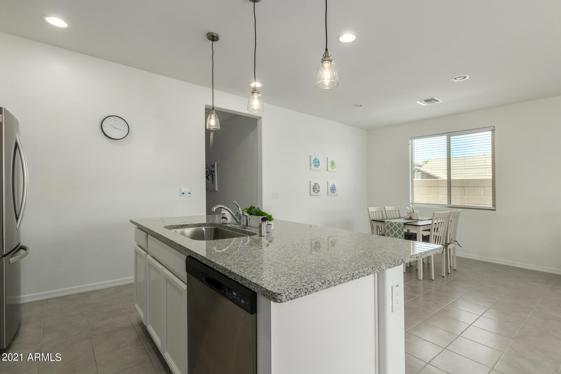 1507 South Honeysuckle Lane Gilbert, AZ 85296 - Photo 11 of 32 a kitchen with center island table and chairs in it
