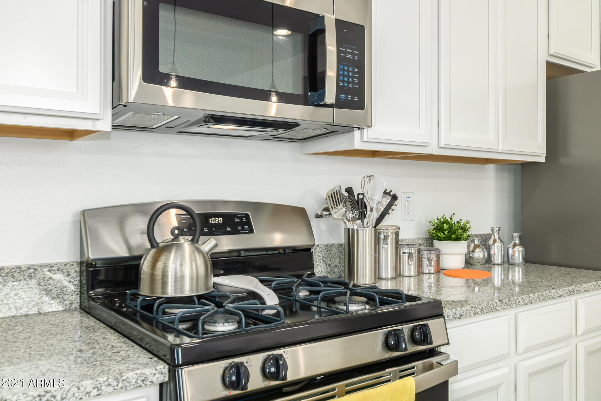 1507 South Honeysuckle Lane Gilbert, AZ 85296 - Photo 13 of 32 a kitchen with a stove and cabinets