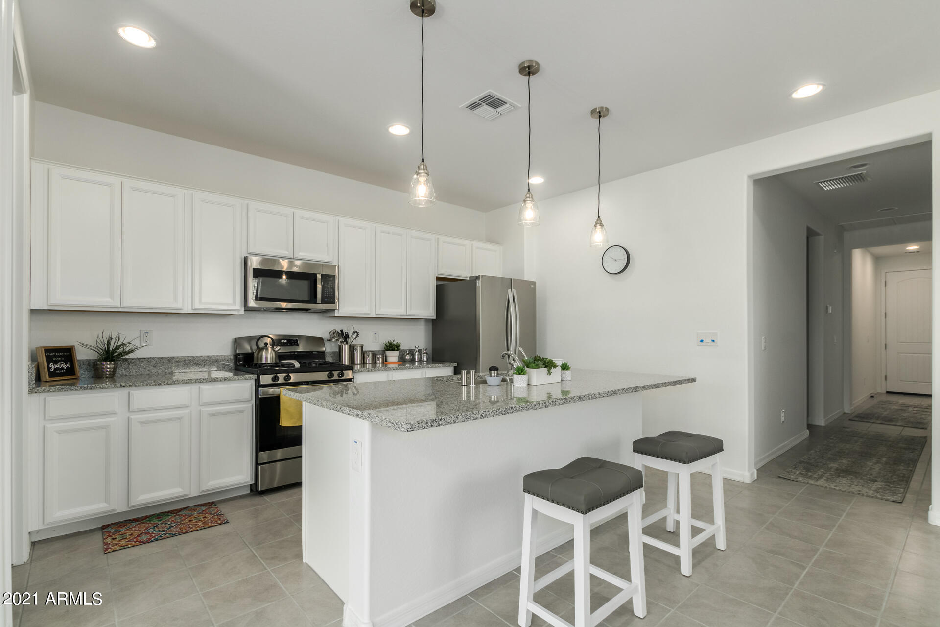 1507 South Honeysuckle Lane Gilbert, AZ 85296 - Photo 14 of 32 a kitchen with stainless steel appliances kitchen island granite countertop a sink and cabinets