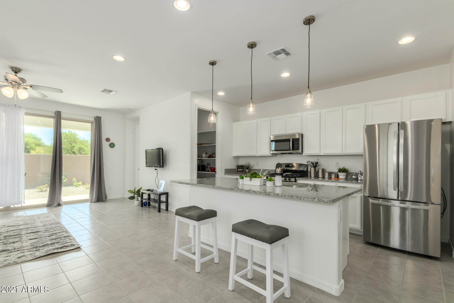 1507 South Honeysuckle Lane Gilbert, AZ 85296 - Photo 15 of 32 a kitchen with refrigerator a stove and chairs