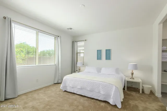 a bedroom with a bed and a night stand