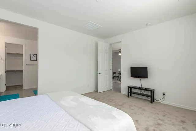 a bedroom with a bed a lamp and a window