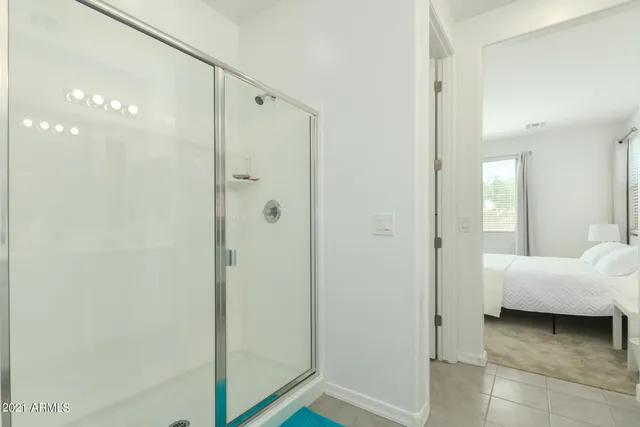 a bathroom with a double vanity sink toilet a large mirror a shower and bathtub