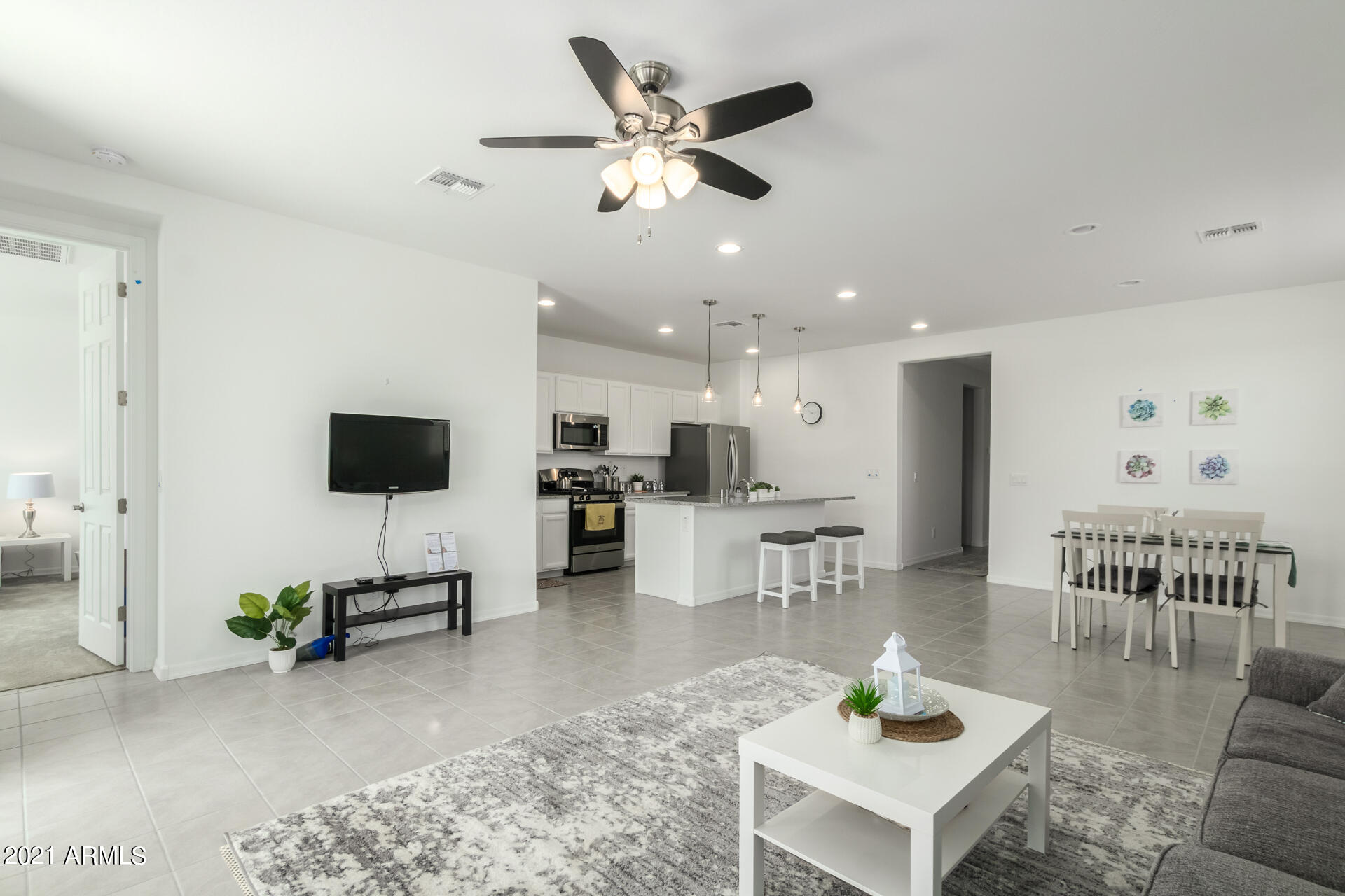 1507 South Honeysuckle Lane Gilbert, AZ 85296 - Photo 5 of 32 a living room with furniture and a flat screen tv