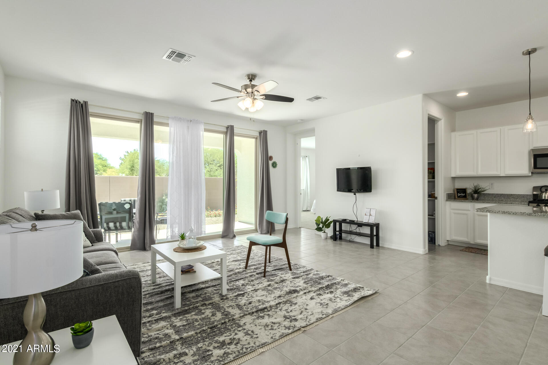 1507 South Honeysuckle Lane Gilbert, AZ 85296 - Photo 6 of 32 a living room with furniture and a flat screen tv