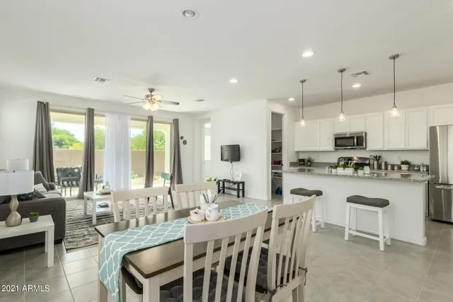a living room with furniture and large windows