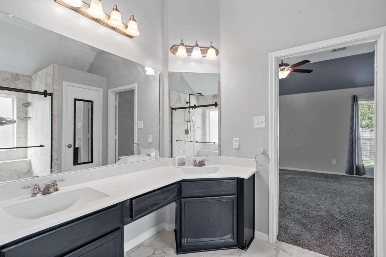 12126 Walden Road Montgomery, TX 77356 - Photo 20 of 50 Great space is found in this 2023 remodeled primary bathroom. The newly added linen closet's reflection shows in the mirror.