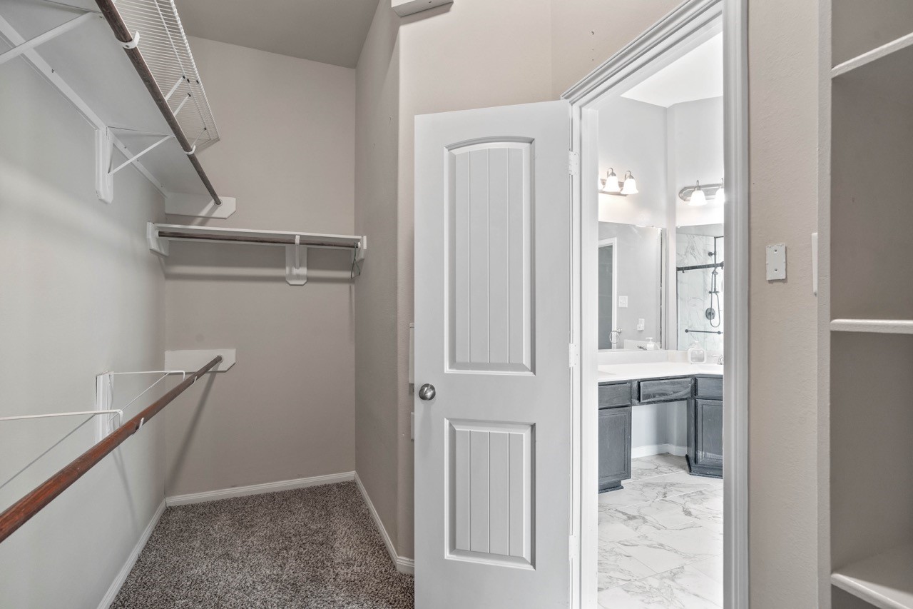 12126 Walden Road Montgomery, TX 77356 - Photo 24 of 50 Spacious primary walk-in closet with ample shelving and hanging rods.