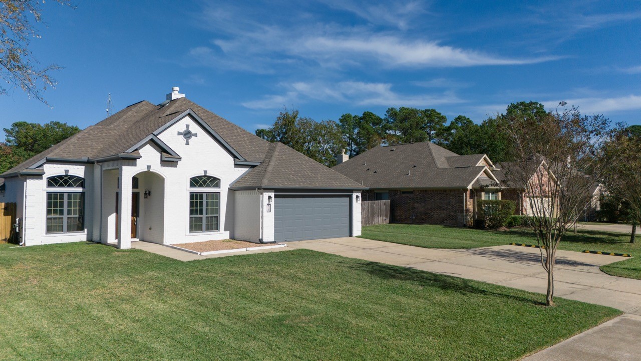 12126 Walden Road Montgomery, TX 77356 - Photo 4 of 50 The spacious double-wide driveway offers ample parking and the ease of turning around within the driveway for an easy way out.