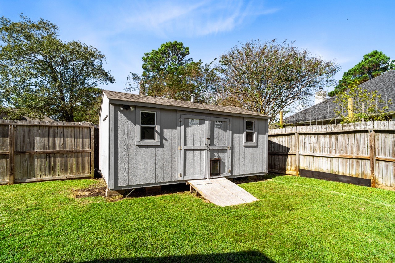 12126 Walden Road Montgomery, TX 77356 - Photo 40 of 50 Make this your own hideaway and don't forget about little Max too, as he has his own doggie door!! This She Shed/Man Cave is equipped with its own AC, electricity and fans. OR use it to store lawn equipment within.