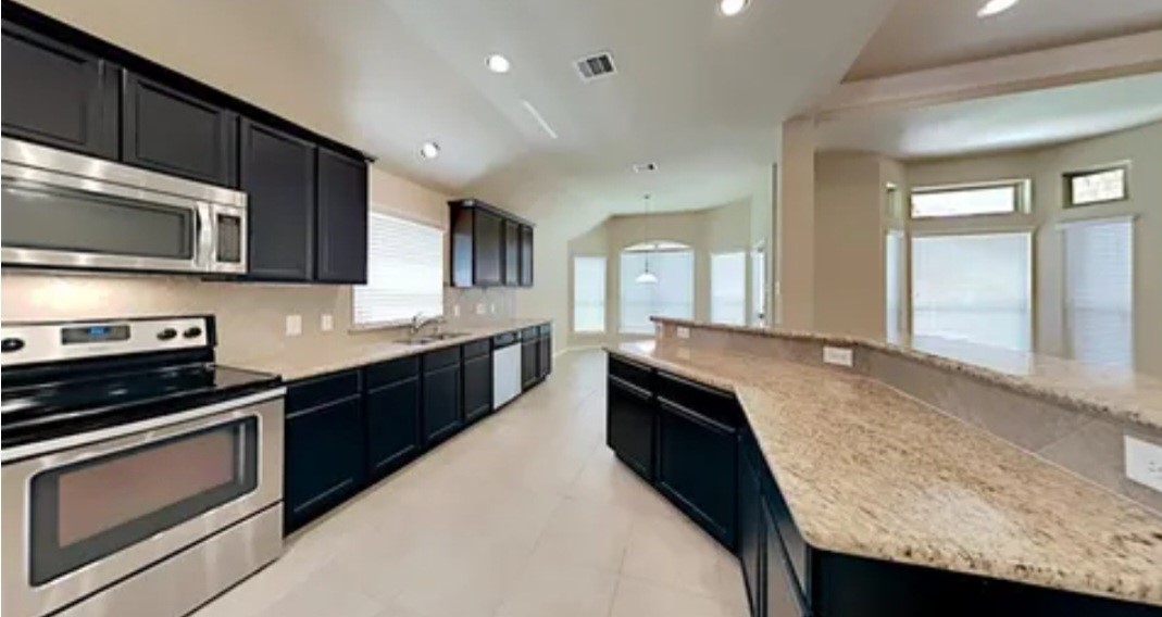 12126 Walden Road Montgomery, TX 77356 - Photo 48 of 50 Original kitchen layout and colors before sellers remodeled and added extra counter/cabinet space. What a difference the newly remodeled kitchen with new appliances and custom cabinets make!!