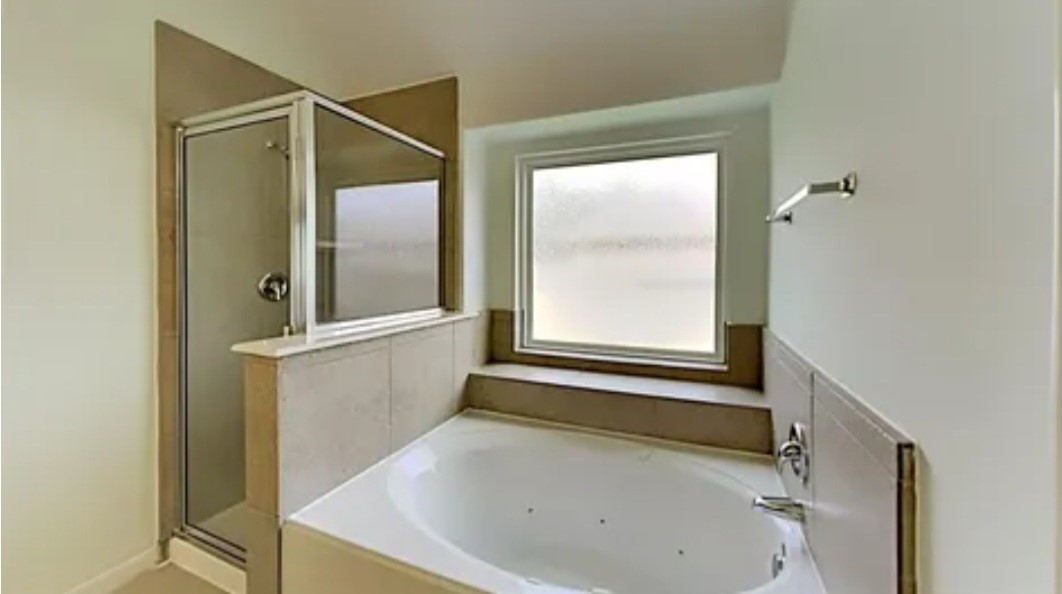 12126 Walden Road Montgomery, TX 77356 - Photo 49 of 50 The original primary bathroom before the sellers remodeled in 2023 by turning the shower into a linen closet and making the tub area the new updated shower.