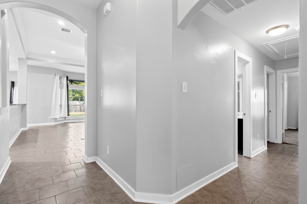 12126 Walden Road Montgomery, TX 77356 - Photo 10 of 50 Entryway leading to kitchen and living area to the left. The guest bathroom, garage, storage closet and 2 bedrooms are down the hall to the right.