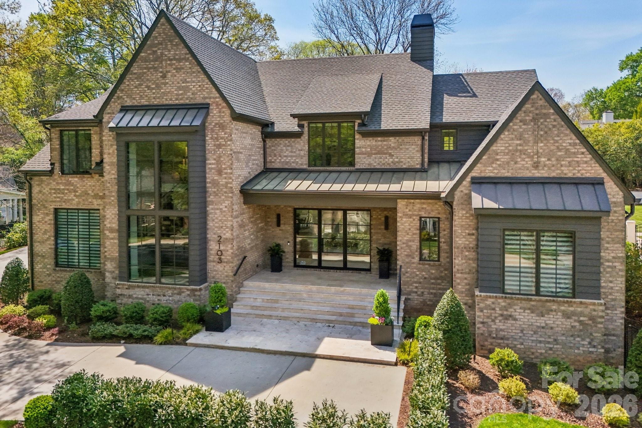 2103 Cortelyou Road Charlotte, NC 28211 - Photo 1 of 45 a front view of a house with garden