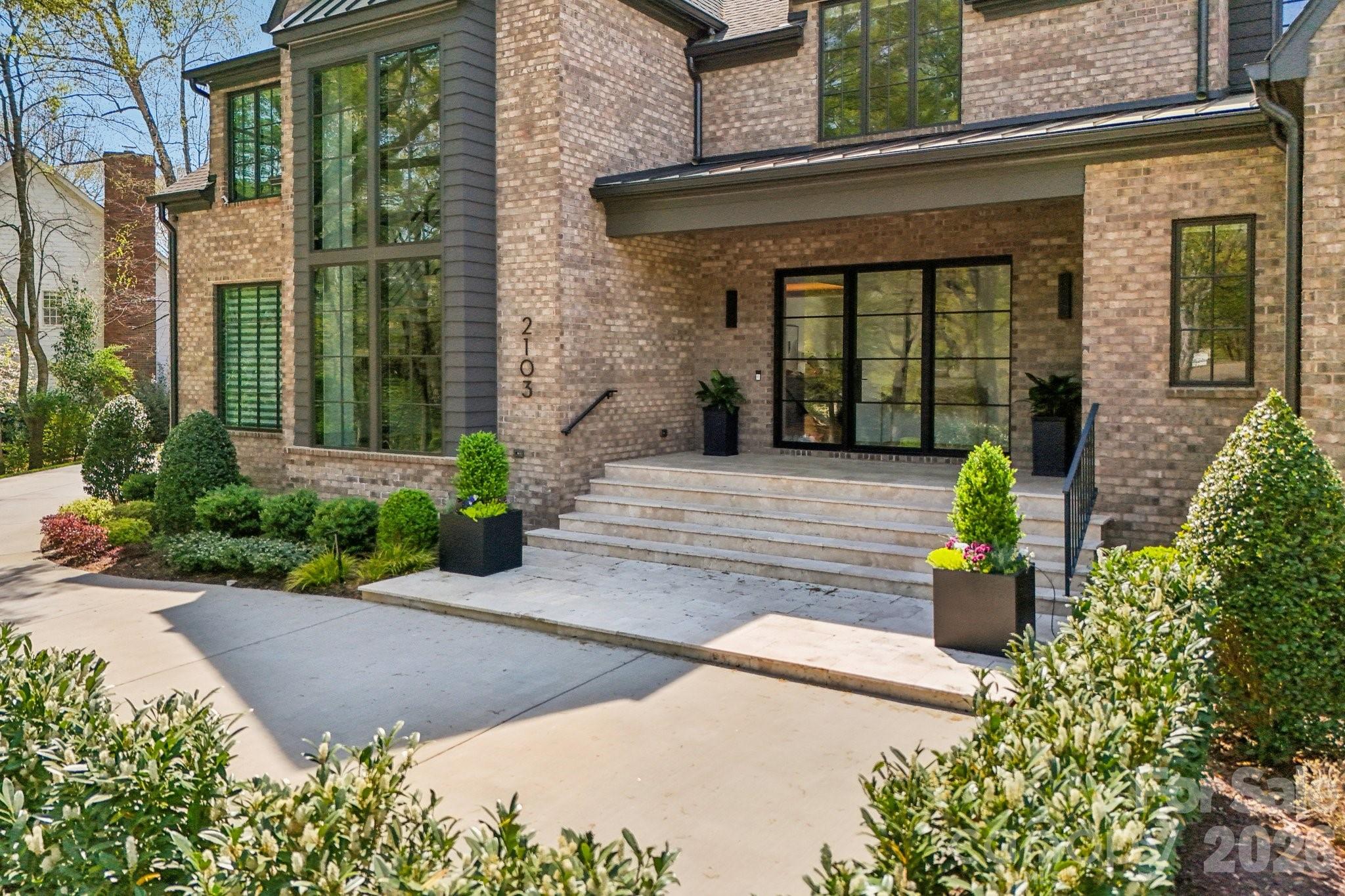2103 Cortelyou Road Charlotte, NC 28211 - Photo 3 of 45 front view of a brick house with potted plants