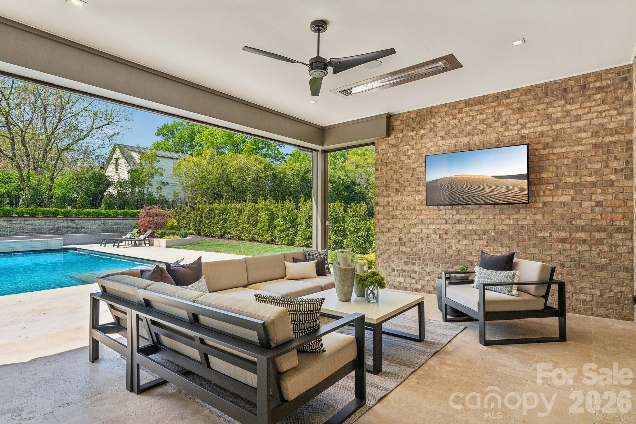 2103 Cortelyou Road Charlotte, NC 28211 - Photo 36 of 45 a living room with furniture a flat screen tv and a floor to ceiling window