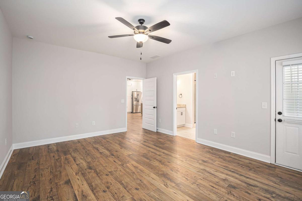 138 Crest Pointe Bremen, GA 30110 - Photo 16 of 24 an empty room with wooden floor and ceiling fan