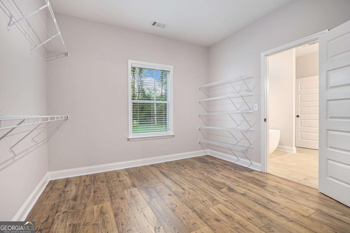 138 Crest Pointe Bremen, GA 30110 - Photo 19 of 24 an empty room with wooden floor and windows