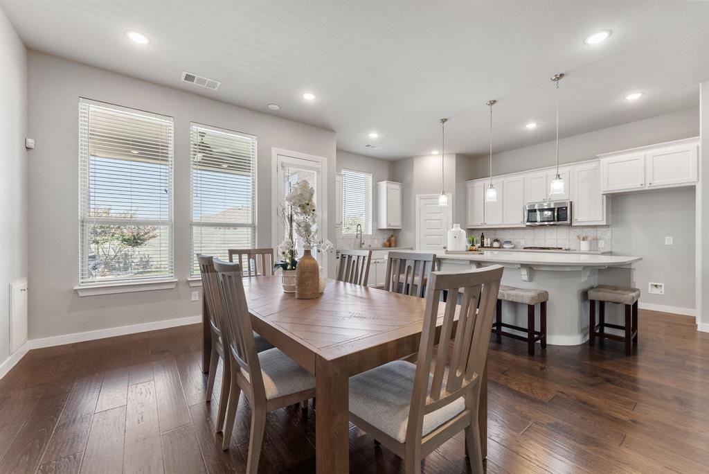 1908 Quail Lane Argyle, TX 76226 - Photo 13 of 30 an open kitchen with kitchen island a dining table and chairs