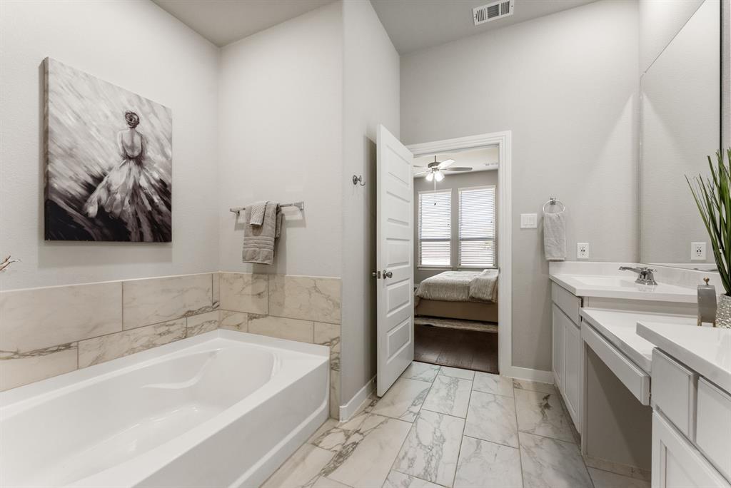 1908 Quail Lane Argyle, TX 76226 - Photo 16 of 30 a bathroom with a tub a sink and mirrors