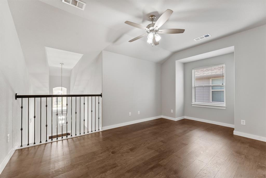 1908 Quail Lane Argyle, TX 76226 - Photo 20 of 30 a view of an empty room with wooden floor and a window