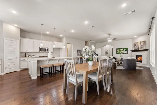 a view of kitchen with cabinets table and chairs