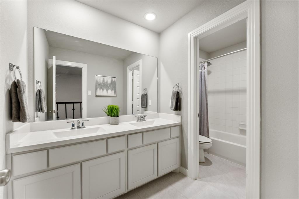 1908 Quail Lane Argyle, TX 76226 - Photo 24 of 30 a bathroom with a double vanity sink toilet and mirror
